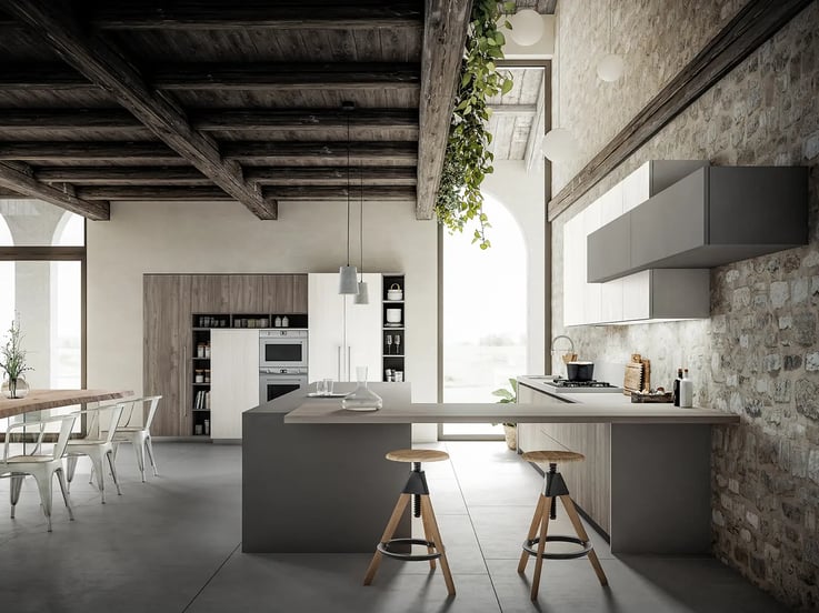 A minimalistic and rustic gray kitchen featuring a U-shaped countertop arrangement and a pair of stools.