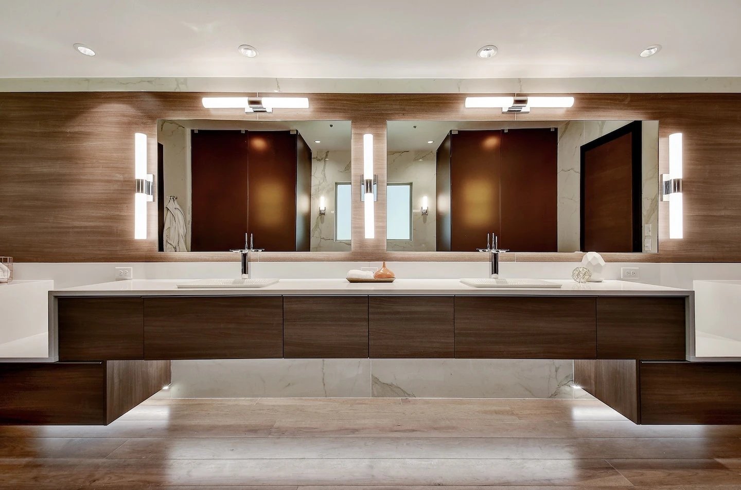 Custom bathroom vanity with under cabinet lighting and mirror lighting.
