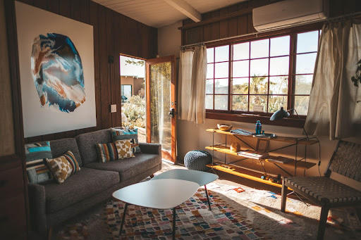 A cozy living room with natural light and patterned accent elements.